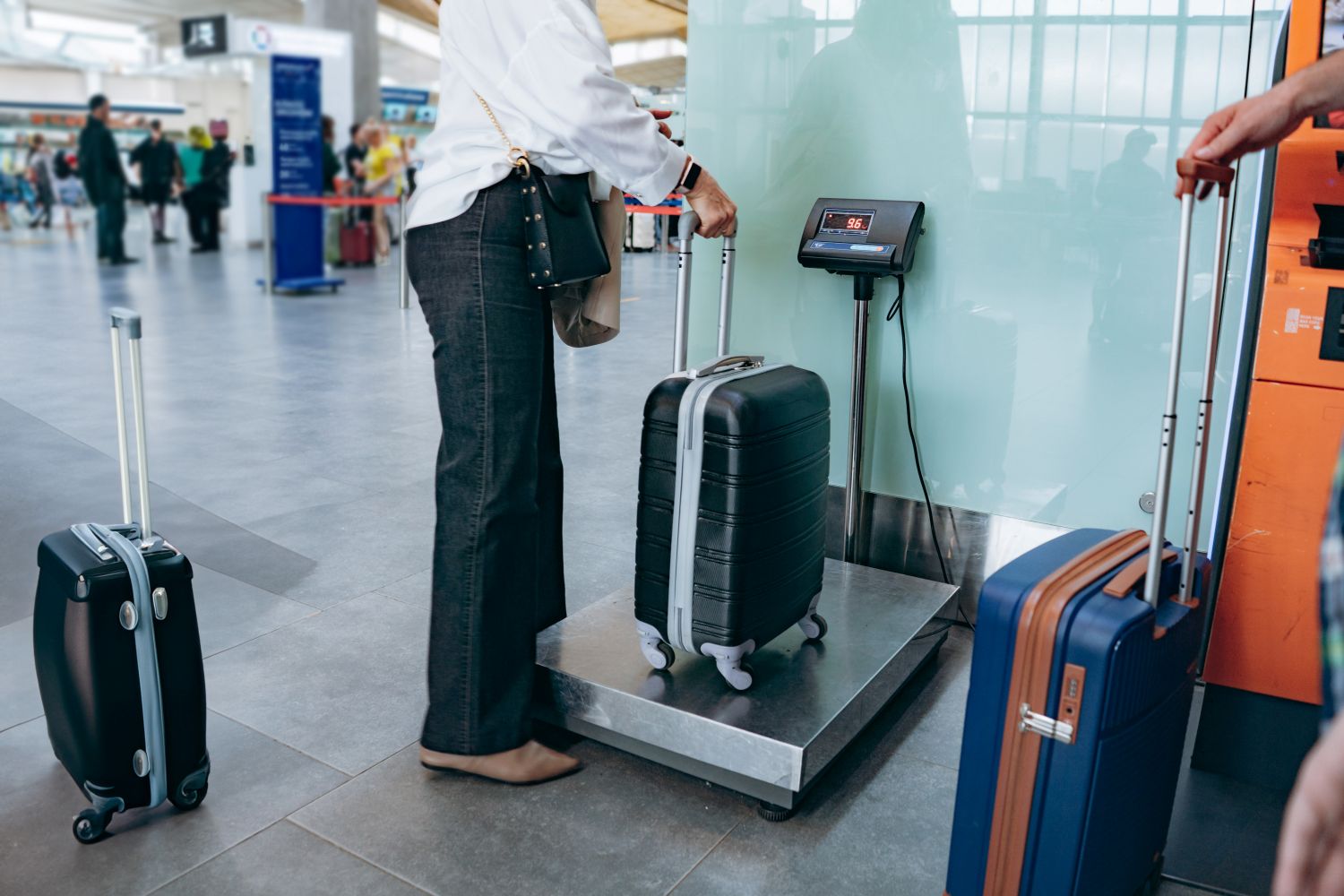 woman weighing suitcase